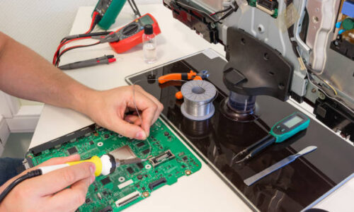 TV repair in the service center, engineer soldering electronic components
