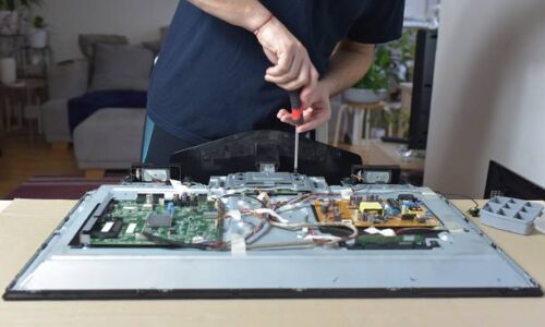 The man repairing broken tv at home